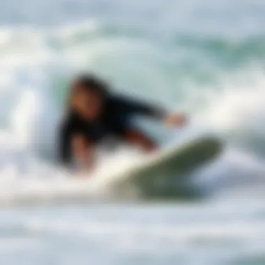 An action shot of a surfer navigating waves with a focus on the nose guard functionality