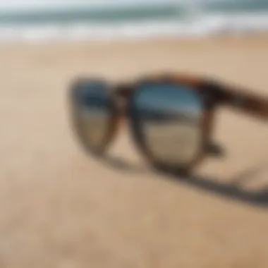 Stylish Surf Sunglasses by the Shore Pair of surf sunglasses on a sandy beach