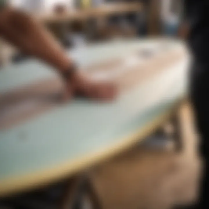 Close-up of a surfboard being repaired with epoxy resin and fiberglass cloth