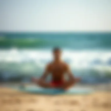 Surfer meditating on the beach for mental focus