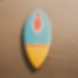 A colorful surfboard resting on the sandy beach