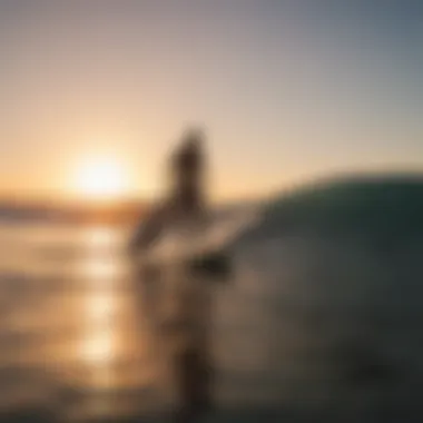 Surfers riding the waves at sunset