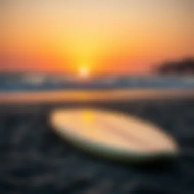 Surfboard at Sunset A surfboard resting on the sandy beach at sunset