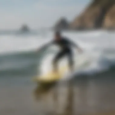 An instructor demonstrating a surfing technique on the beach