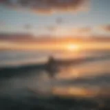 A vibrant sunset over the Pacific Ocean with surfers riding waves