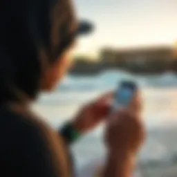 A surfer checking the Surfline Pro app on a smartphone while at the beach.