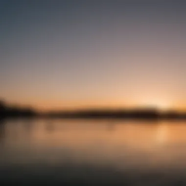 A serene sunset over the wakeboard park with silhouettes of riders