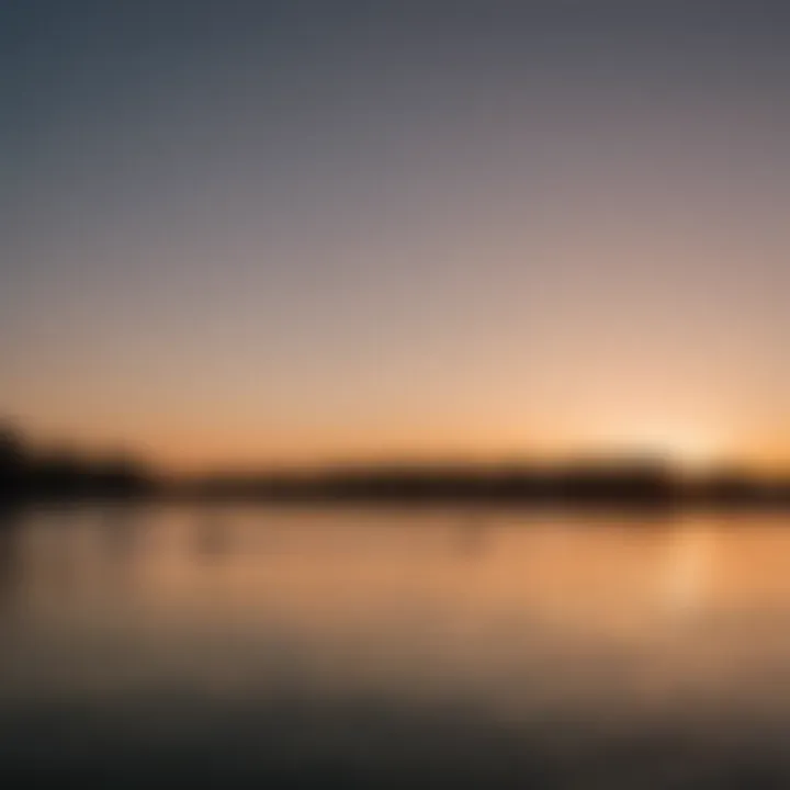 A serene sunset over the wakeboard park with silhouettes of riders