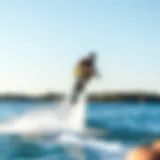 A wakeskater performing a trick over water