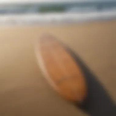 A vintage surfboard displayed on a sandy beach