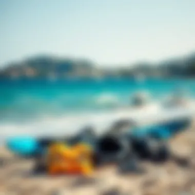 Kitesurfing gear laid out on the beach with the scenic coastline in the background