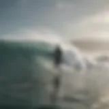 Surfer riding a wave in a misty environment