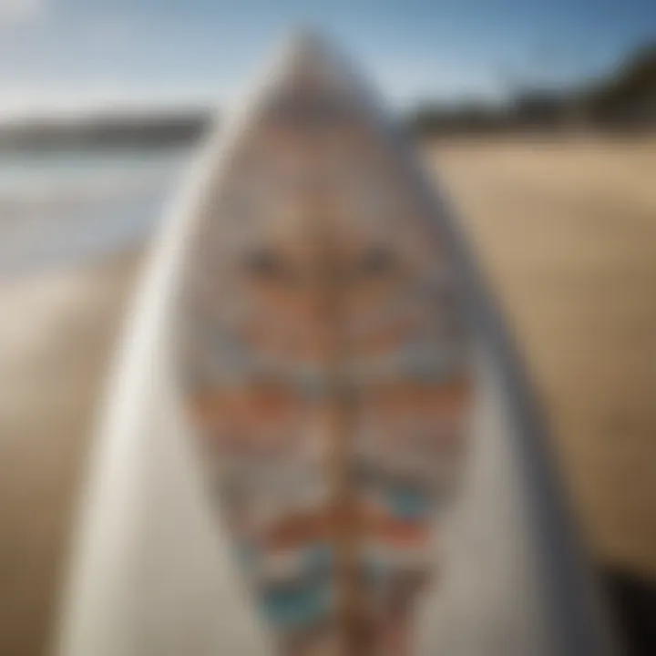 A close-up of a surfer's board adorned with local art and stickers