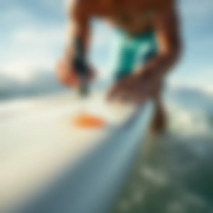 Applying Repair Resin to Surfboard Surfer applying repair resin to a ding