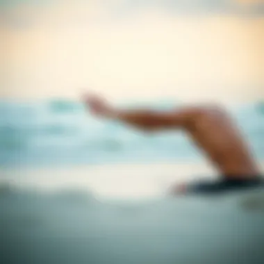Surfer practicing stretching exercises on the beach