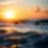 A breathtaking sunrise over the ocean with surfers catching waves.