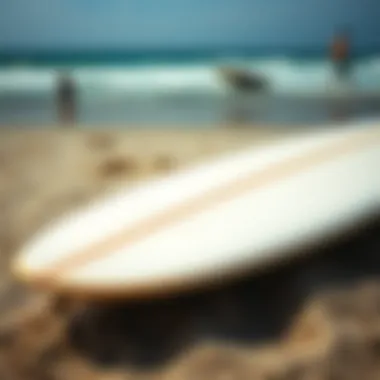 Craftsmanship in Surfboards: Art Meets Function A close-up of a surfboard on the sandy beach, showcasing its design and craftsmanship.