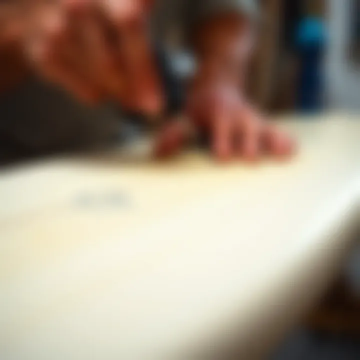 Close-up of a surfboard being sanded with precision tools