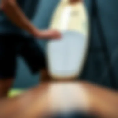 Demonstration of surfboard pad installation on a surfboard