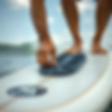 Surfer adjusting gorilla traction pad on a surfboard