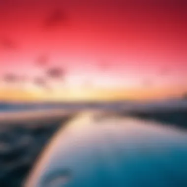 Surfboard Resting on the Beach at Sunset Surfboard resting on the beach with sunset in background