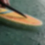 Close-up of a surfboard wax scraper with textured surface