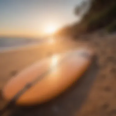 Surfboard on Sand at Sunset A surfboard resting on the sand with sunset in the background