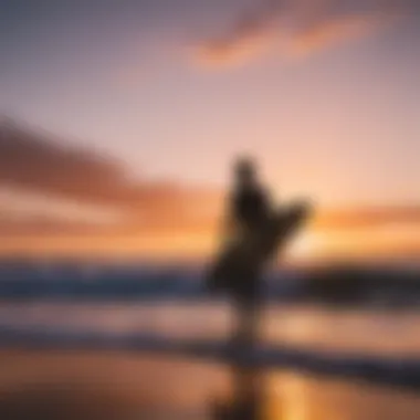 Surfer silhouetted against a vibrant sunset sky