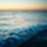 Calm ocean waves lapping against the shore at sunset