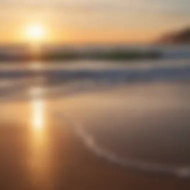 A tranquil beach scene with the sun dipping below the horizon