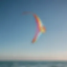 A vibrant training kite soaring high against a clear blue sky