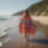 Vibrant towel ponchos displayed on a sandy beach