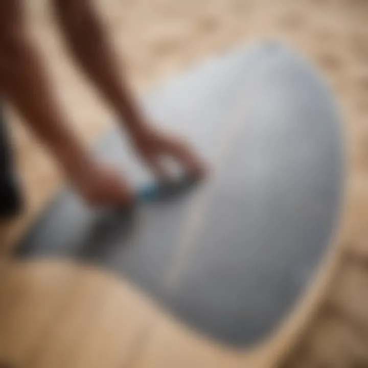 Surfboard being prepared for grip tape installation