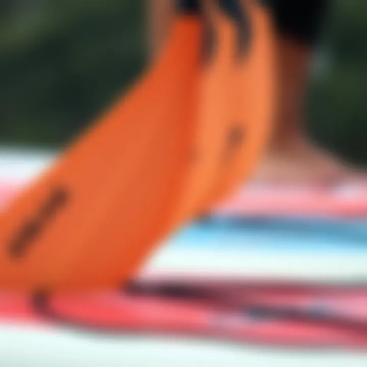 A close-up view of paddle variations used for different SUP widths
