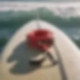 Detail of a surf leash attached to a surfboard