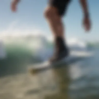 Surfer wearing Vans booties while riding a wave